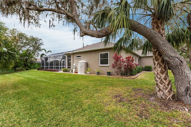 exterior space featuring a lanai and a lawn