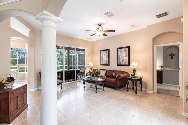 living room with light tile patterned floors, ceiling fan, and decorative columns