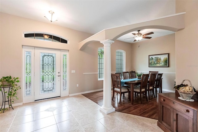 entrance foyer featuring ornate columns, light tile patterned flooring, and ceiling fan