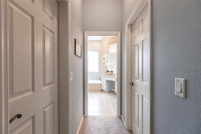 hall with light tile patterned floors