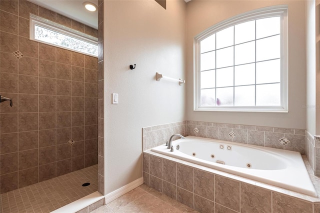 bathroom featuring separate shower and tub, tile patterned flooring, and a wealth of natural light