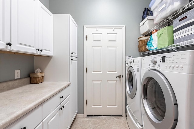 washroom featuring cabinets, independent washer and dryer, and light tile patterned flooring