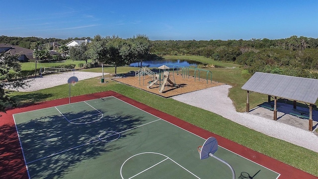 view of sport court featuring playground community, a yard, and a water view