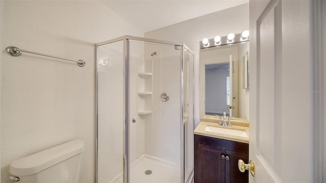 bathroom with toilet, vanity, a shower with shower door, and lofted ceiling