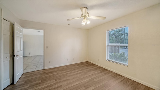 unfurnished room featuring ceiling fan and light wood-type flooring