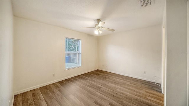 empty room featuring a textured ceiling, ceiling fan, and light hardwood / wood-style flooring