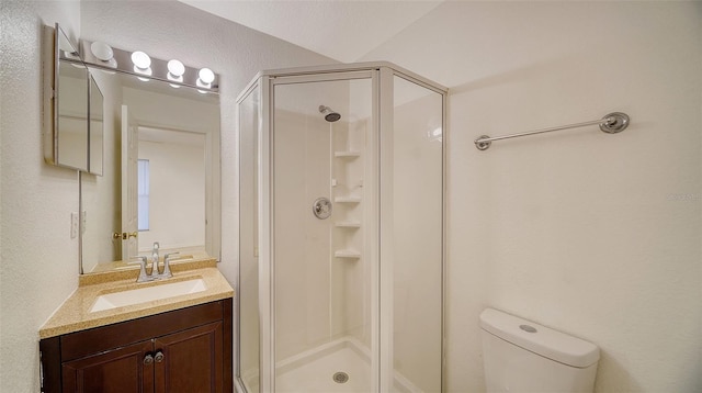 bathroom with walk in shower, vanity, and toilet