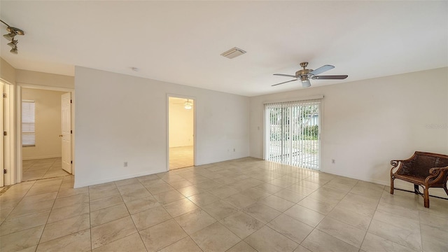 empty room featuring ceiling fan and light tile patterned floors