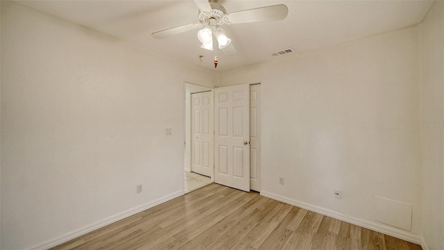 empty room featuring ceiling fan and light wood-type flooring