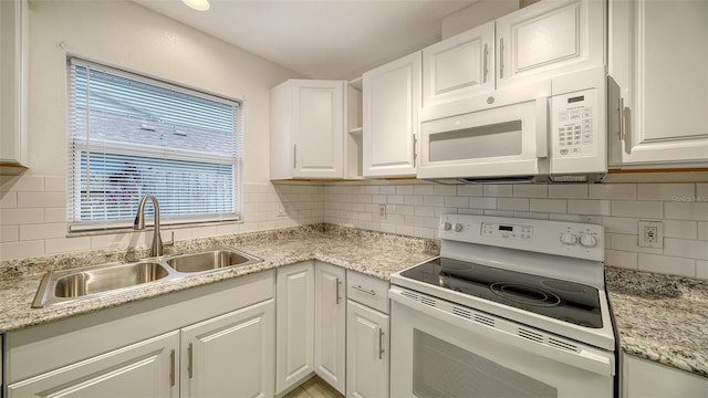 kitchen with sink, white appliances, and white cabinetry