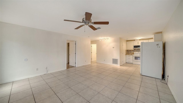 unfurnished living room with ceiling fan and light tile patterned floors