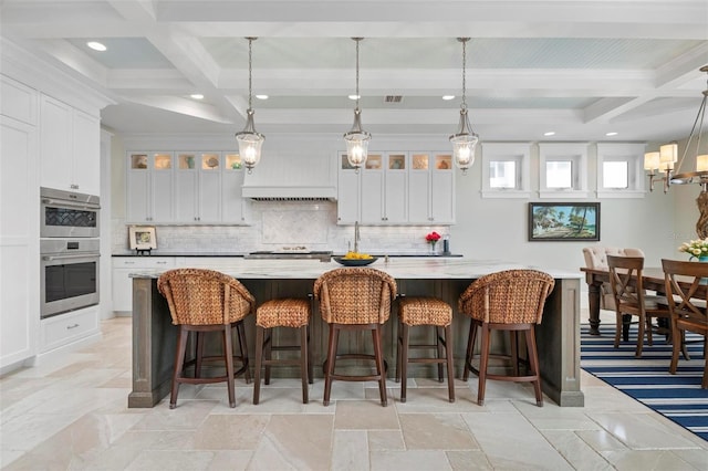 kitchen featuring backsplash, glass insert cabinets, double oven, beam ceiling, and white cabinets