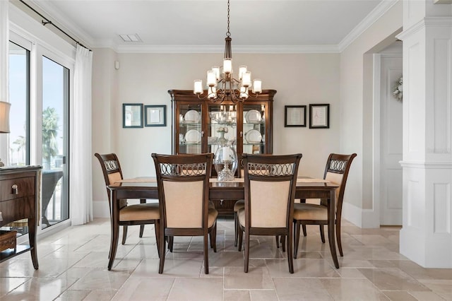 dining room featuring crown molding, a notable chandelier, baseboards, and visible vents