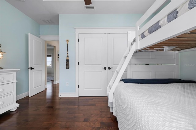 unfurnished bedroom with visible vents, baseboards, a closet, and wood finished floors