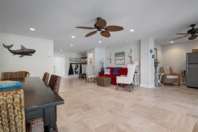 living room with a ceiling fan, recessed lighting, and baseboards