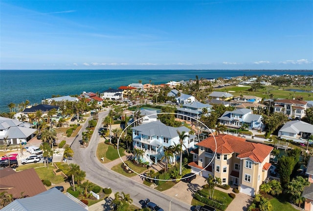 drone / aerial view featuring a residential view and a water view