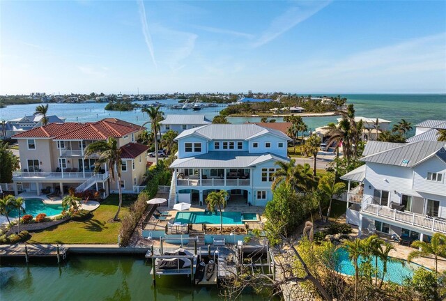 birds eye view of property with a water view and a residential view