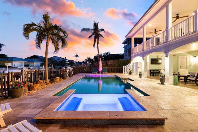 view of pool featuring a patio, an in ground hot tub, a fenced backyard, and ceiling fan