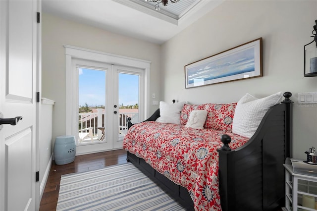 bedroom with access to exterior, french doors, and wood finished floors