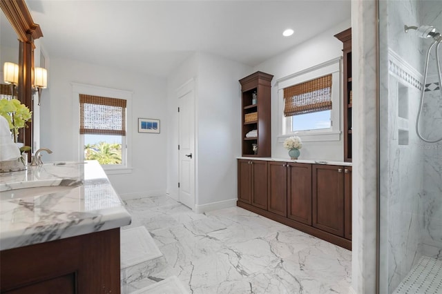 interior space with recessed lighting, a healthy amount of sunlight, marble finish floor, and baseboards