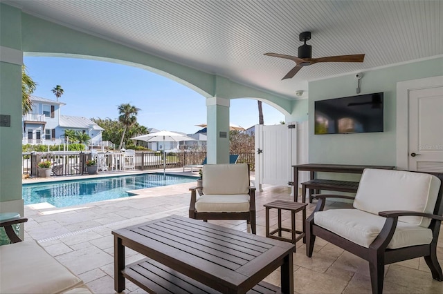 view of patio / terrace featuring a fenced in pool, ceiling fan, outdoor lounge area, and fence