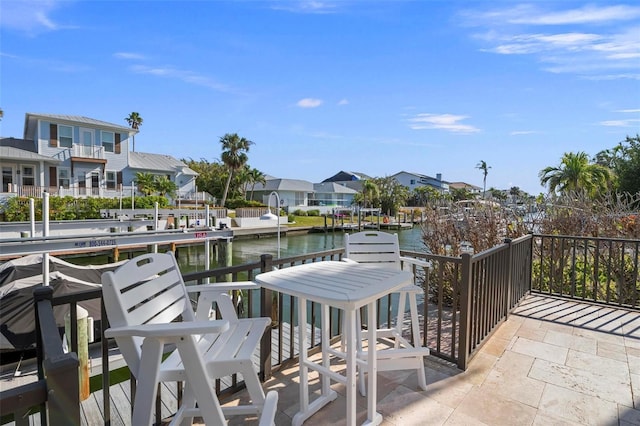 dock area featuring a residential view and a water view