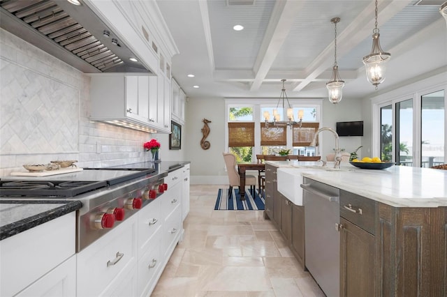 718 Key Royale Dr, Holmes Beach, FL 34217 - kitchen with premium range hood, appliances with stainless steel finishes, a sink, a chandelier, and backsplash