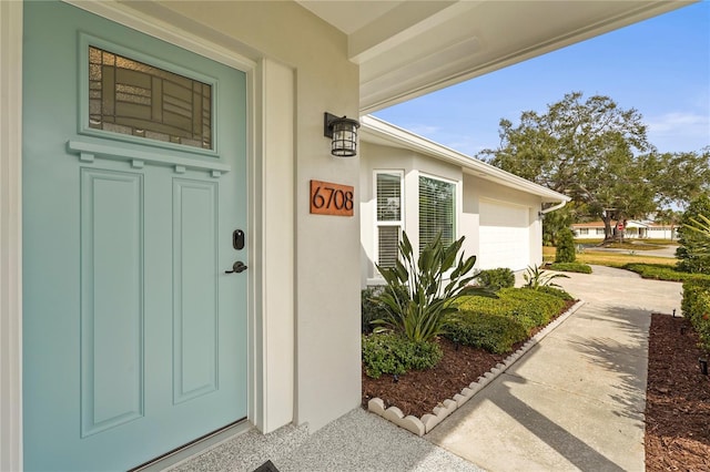 doorway to property with a garage