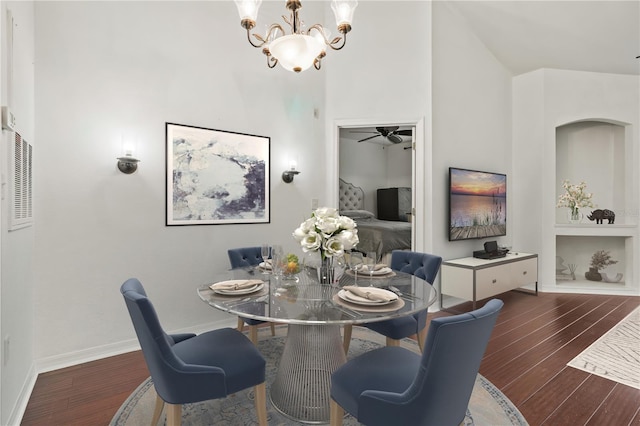 dining space featuring dark hardwood / wood-style floors and an inviting chandelier