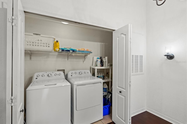 clothes washing area featuring washer and dryer and light tile patterned floors