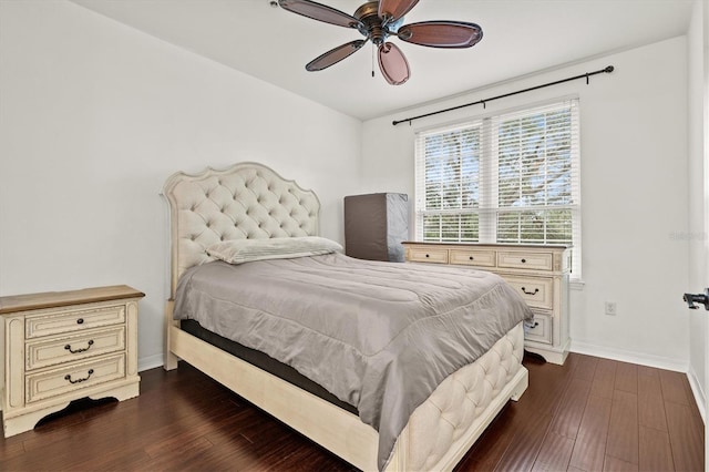 bedroom with dark hardwood / wood-style flooring and ceiling fan