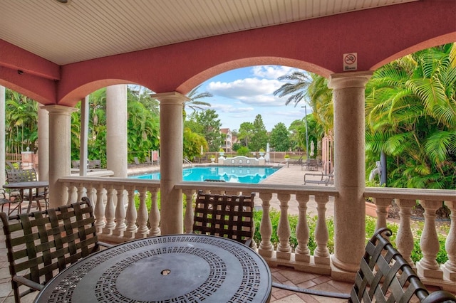 deck with a community pool and a patio area