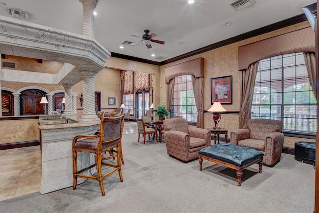 living room with light colored carpet, ornamental molding, decorative columns, and ceiling fan