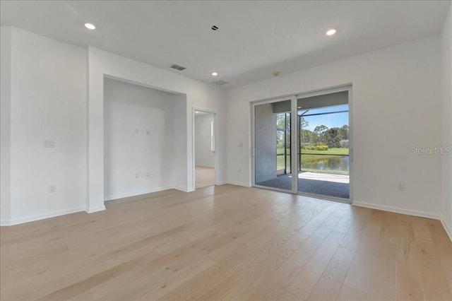 empty room with a water view and light wood-type flooring