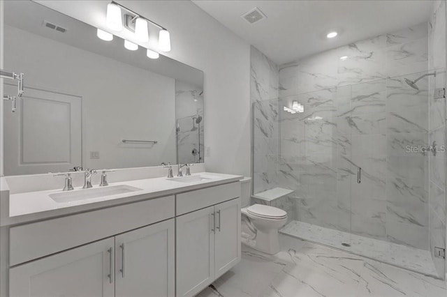 bathroom with toilet, vanity, and a shower with door