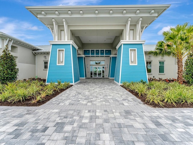 view of exterior entry featuring french doors