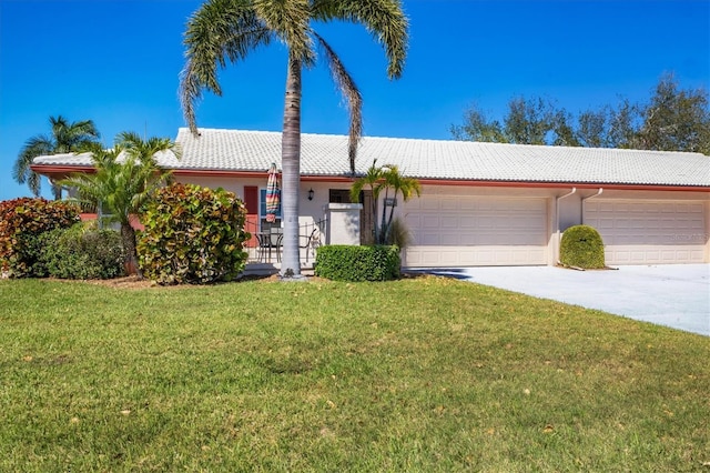 ranch-style house featuring a garage, concrete driveway, a front lawn, and a tiled roof