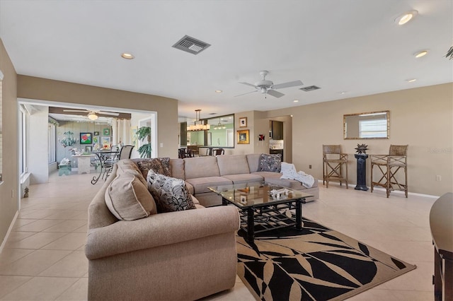 living area with light tile patterned floors, visible vents, recessed lighting, and ceiling fan