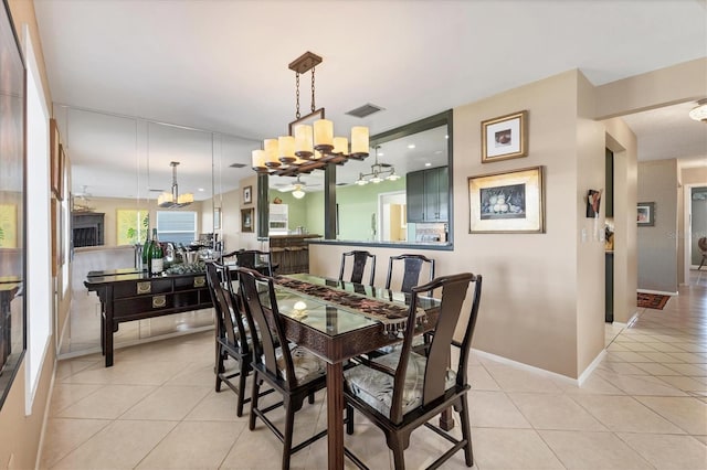 dining area with an inviting chandelier, light tile patterned flooring, baseboards, and visible vents