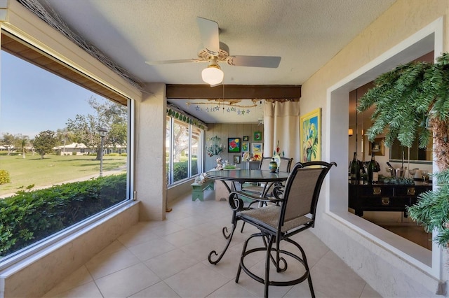 sunroom featuring a ceiling fan