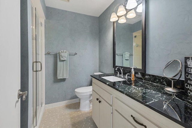 full bath with vanity, tile patterned floors, toilet, and a shower stall