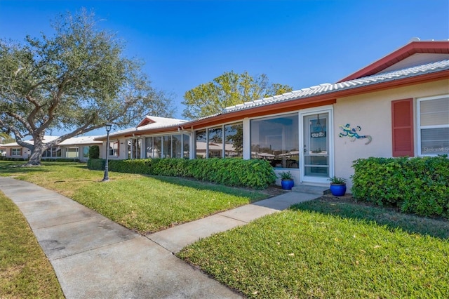 view of front of home with a front yard and stucco siding