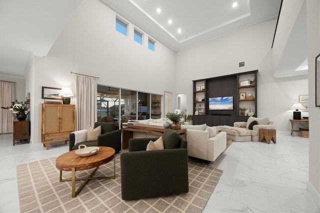 living room with plenty of natural light and a high ceiling