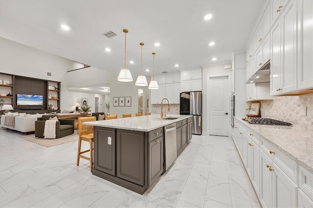 kitchen with sink, white cabinetry, a center island with sink, and stainless steel appliances