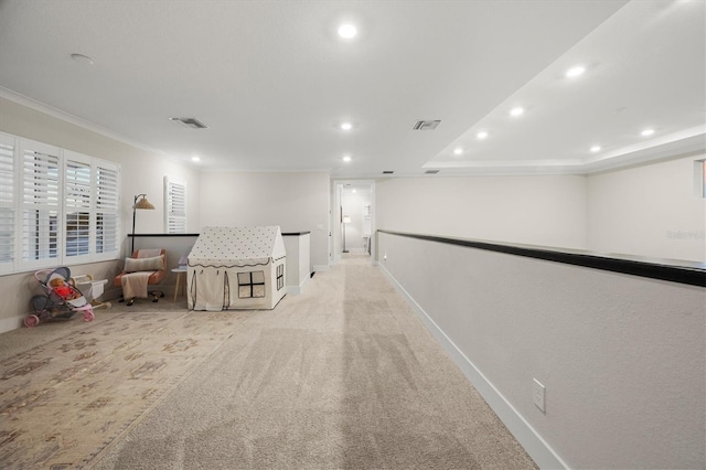 hallway featuring light colored carpet and ornamental molding