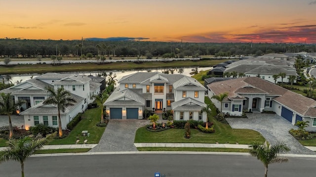 aerial view at dusk with a water view