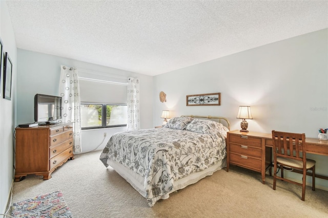 bedroom with light carpet and a textured ceiling