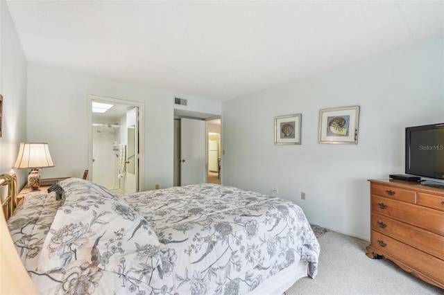 carpeted bedroom with ensuite bath