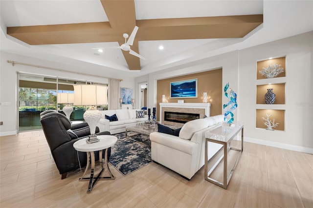 living room featuring built in shelves, a fireplace, and ceiling fan