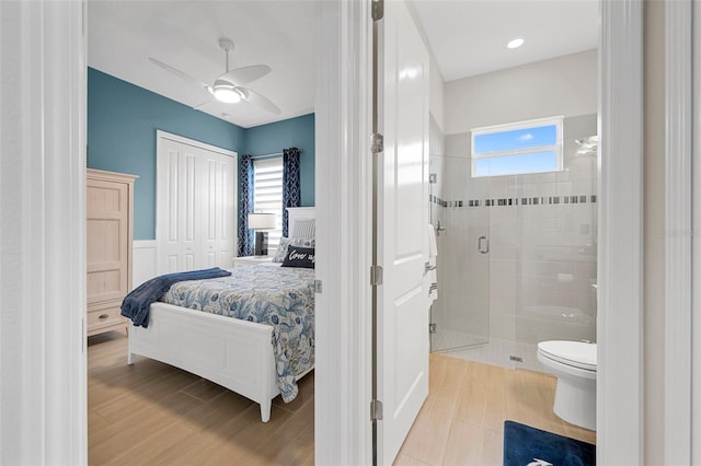 bedroom featuring multiple windows and ceiling fan